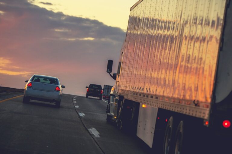 Truck driving on highway with cars