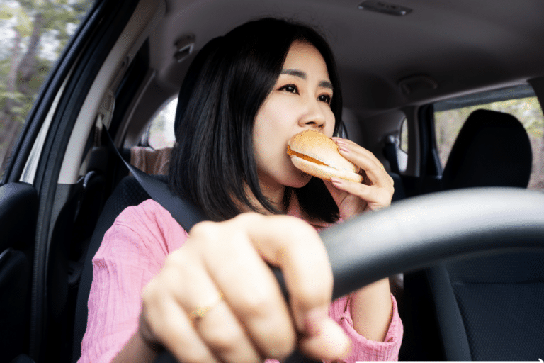 a woman eating while driving