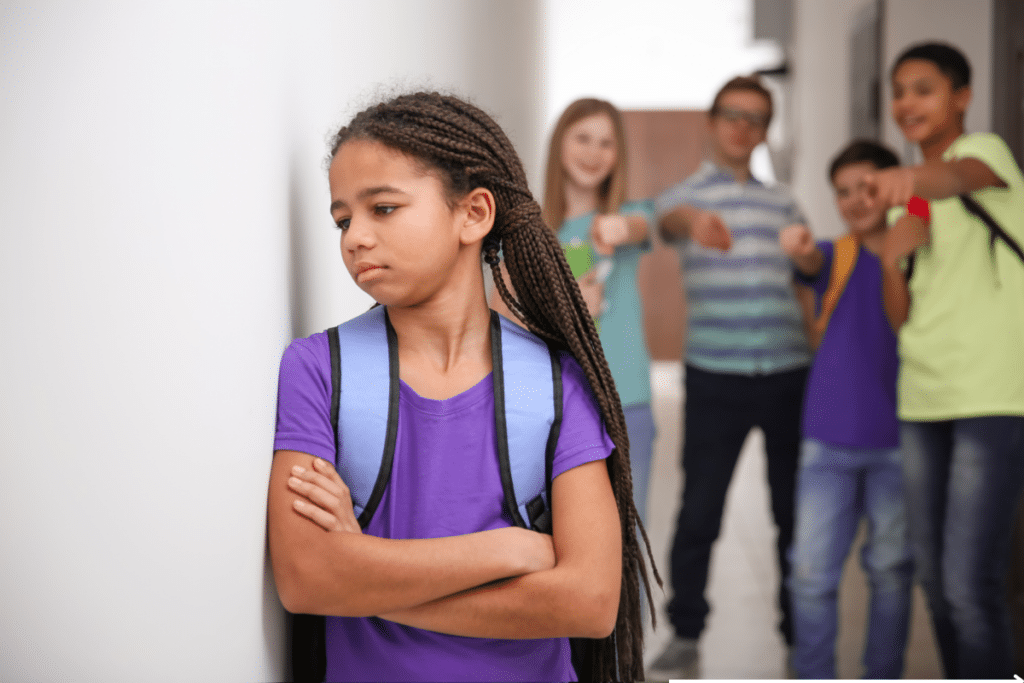 group of students laughing at another student