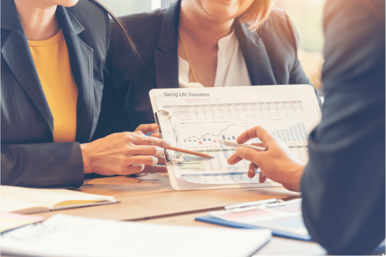 three business lawyers looking at a business chart