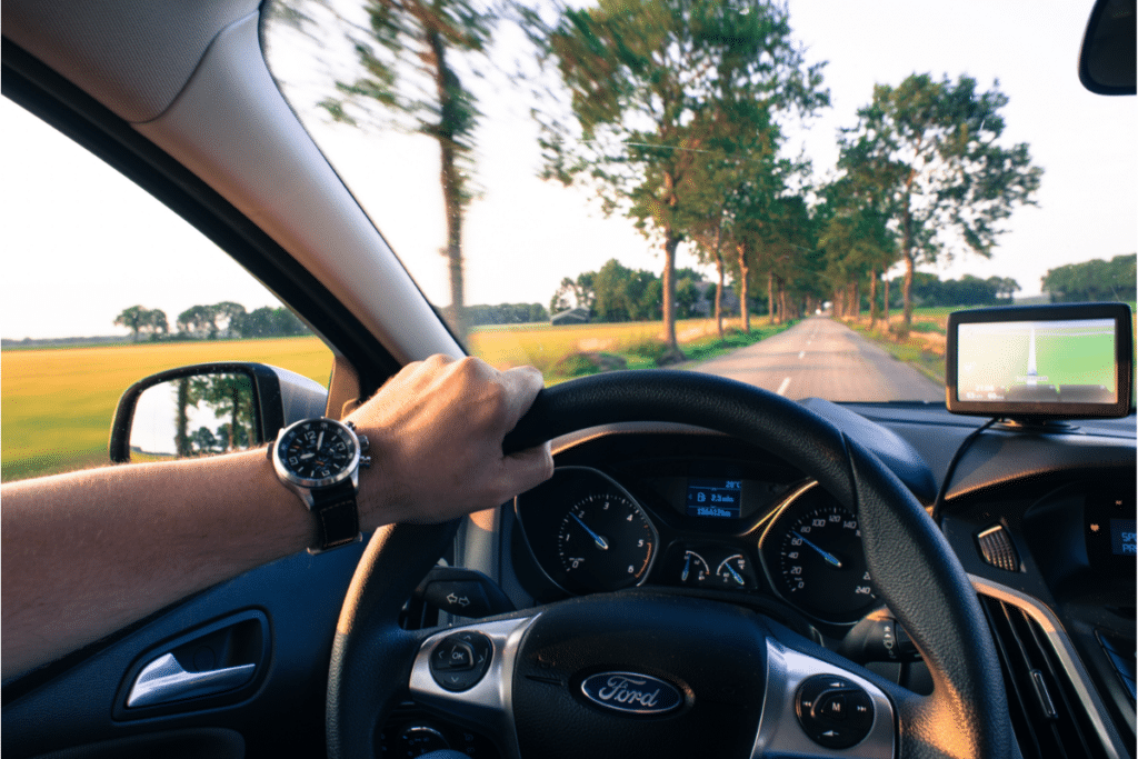 A man driving and using a GPS