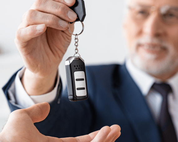 Old man holding a remote car key.